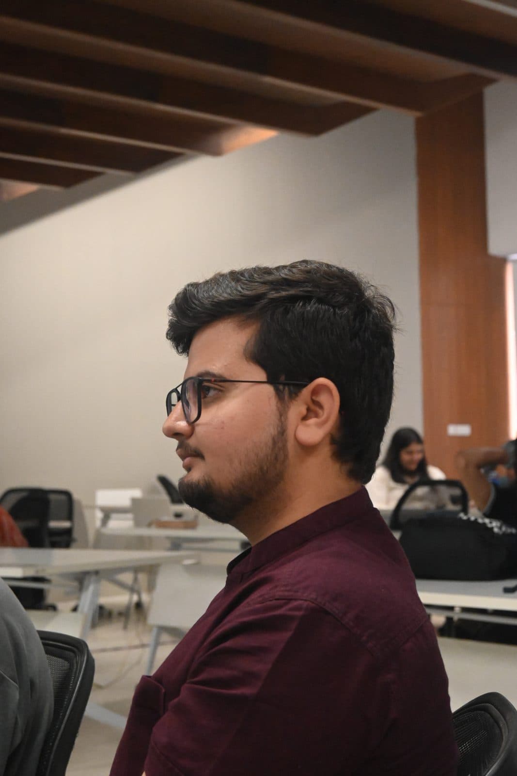Agrim listening to a team's pitch at BuildSpace